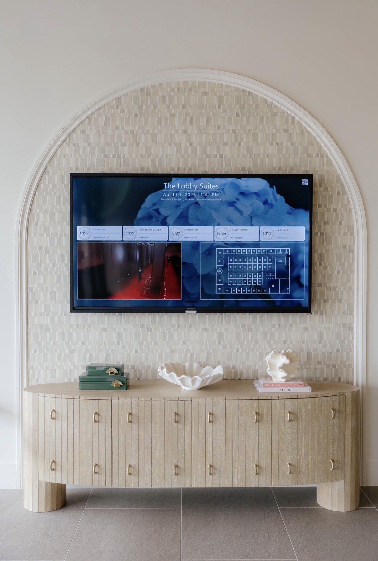 Arched lounge wall with digital directory at The Lobby Suites